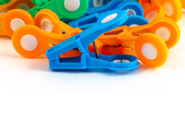 Mavi plastik mandal çok renkli giysiler mandal görüntünün altındaki beyaz bir arka plan ile bir gruba karşı ev kullanımı için.