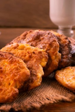 Altın kabuk, bardak süt, ahşap arka plan, dikey çerçeve ile yuvarlak ince tanımlama.