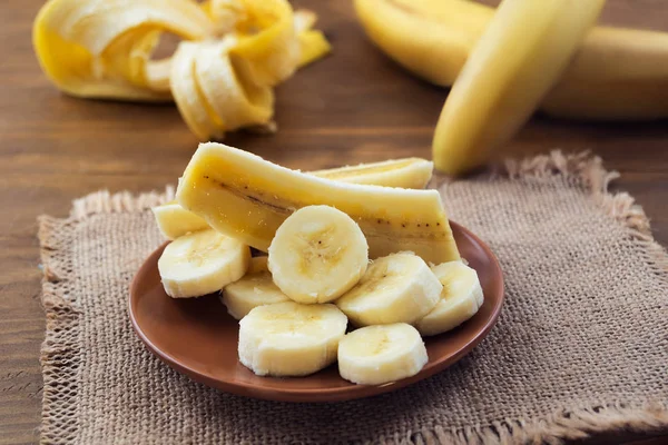 Ripe peeled banana, sliced lengthwise and crosswise into pieces.