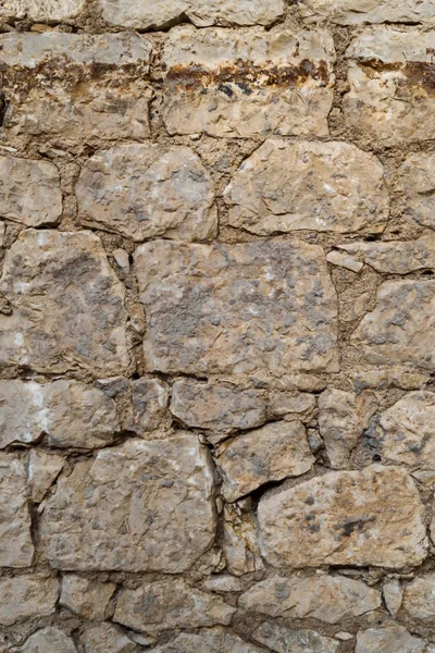 Old stone wall. Construction masonry from different blocks. Stone texture.