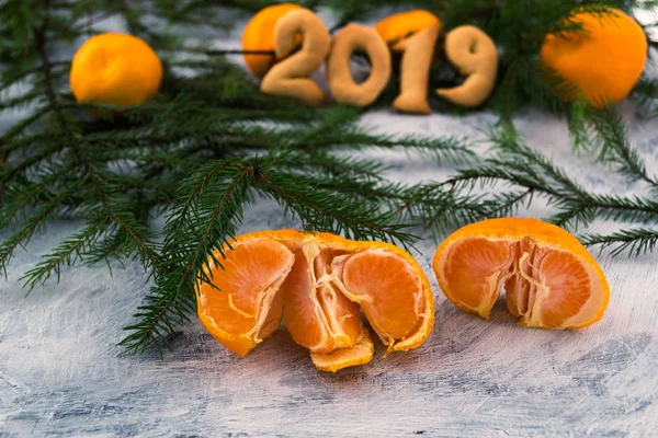 Mandalina ve çam dalları. 2019. açık renkli. Olgunlaşmış tropikal meyve. Portakal dilimleri. Noel hikayesi.