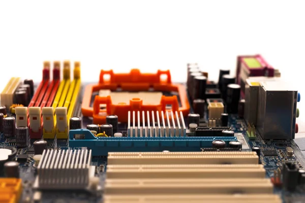 Fragment of the motherboard. Computer component. Isolated on white background. Close-up. Selective focus. Electronic technology.