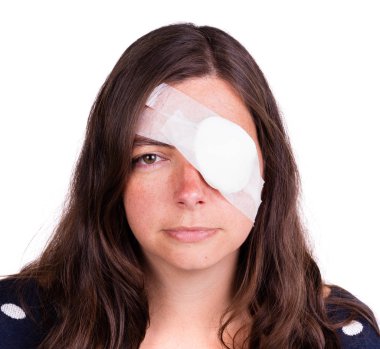 Portrait of woman wearing white eye patch as protection after injury clipart