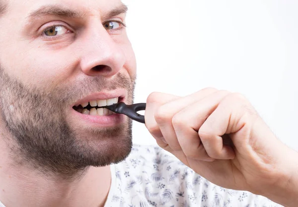 Man Eating Typicaly Dutch Candy Called Dropsleutel Candy Key Isolated — Stock Photo, Image