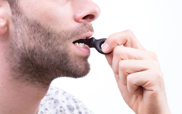 Man Eating Typicaly Dutch Candy Called Dropsleutel Candy Key Isolated — Stock Photo, Image