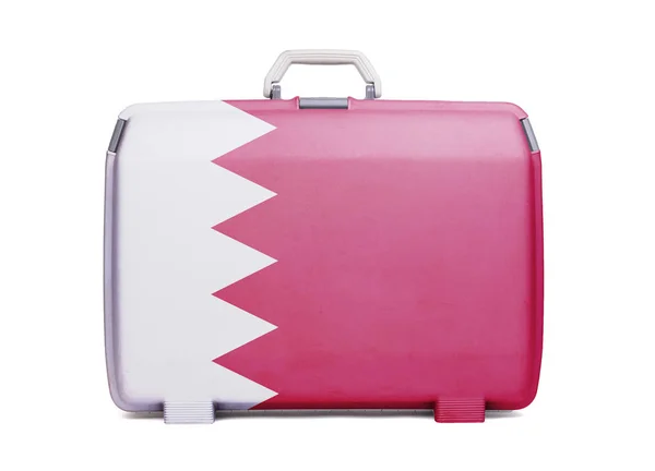 Used plastic suitcase with stains and scratches, printed with flag, Bahrain