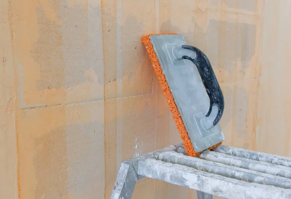 Worker tools - Small steps and a sponge used for plastering