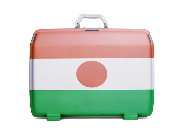 Used plastic suitcase with stains and scratches, printed with flag, Niger