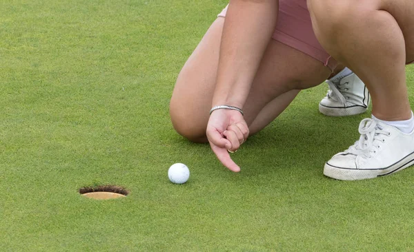 Concept of fun; Playing golf with a finger - Cheating