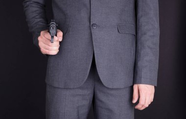 Silahlı bir adam, siyah giysili.