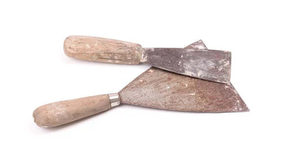 Old putty knifes isolated on a white background