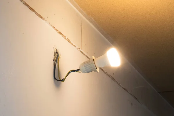 Light bulb hanging on a wall