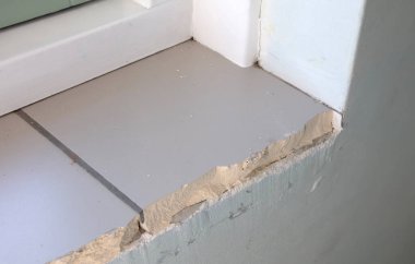 İnşaat halindeki bir evin pencere pervazı kırılmış.