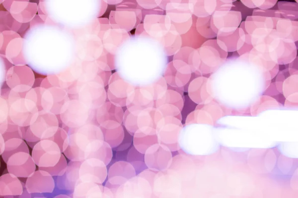 Blurred and bokeh pink led lighting in full screen background.