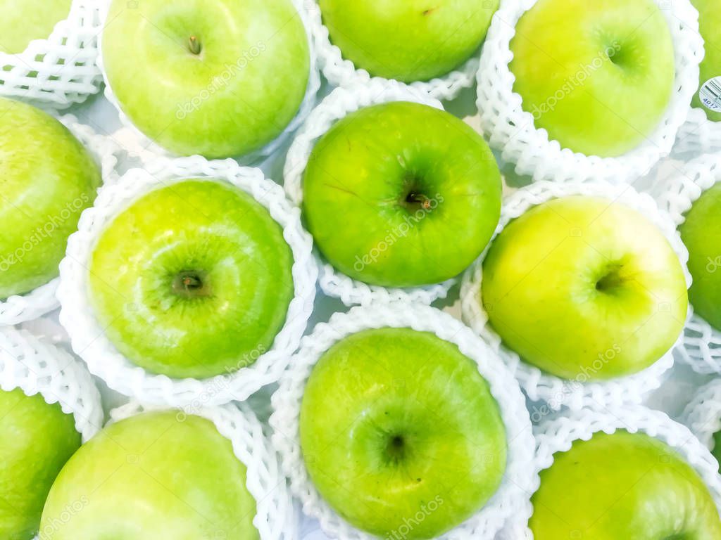 Top view of green apples in net foam full screen background and 