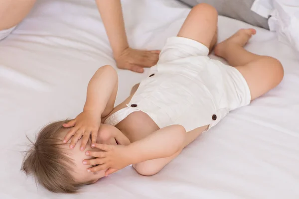 Portrait Little Playful Baby Child Lying Bed Hides Covering Eyes Royalty Free Stock Photos