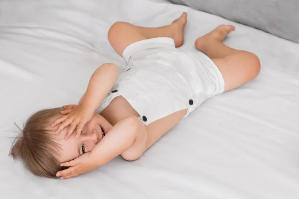 Portrait Little Playful Baby Child Lying Bed Hides Covering Eyes — Stock Photo, Image