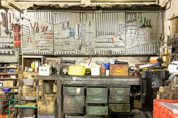 Tools in a car mechanic\'s garage with old drawers