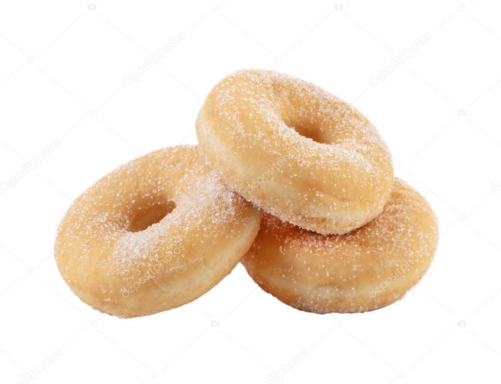 three plain sugar donuts on a white background