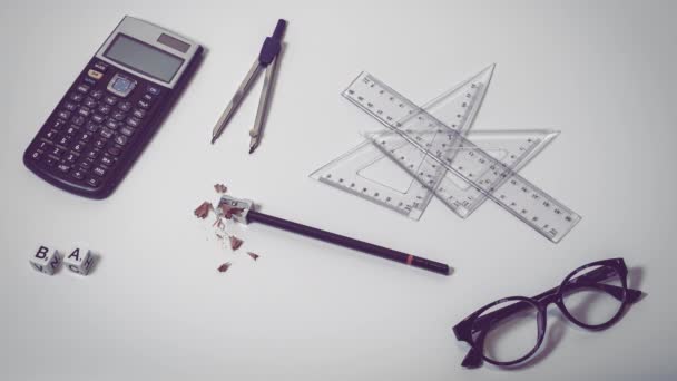 Top view of school supplies on white background with scrabble letters spelling the words back to school - Concept of college student, university  education, learning or high school. — Stock Video