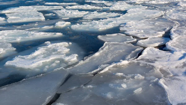 Frozen ice shoreline over the sea. Ice formations at the coast Sea of Japan. Drift ice.