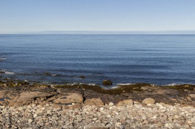 Deniz yüzeyi ve kayalık sahil üzerinde güzel hava görünümü
