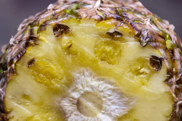 Ripe pineapple and pineapple slices on a wooden background tropical fruits