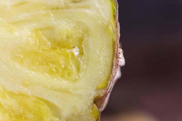 Ripe pineapple and pineapple slices on a wooden background tropical fruits.