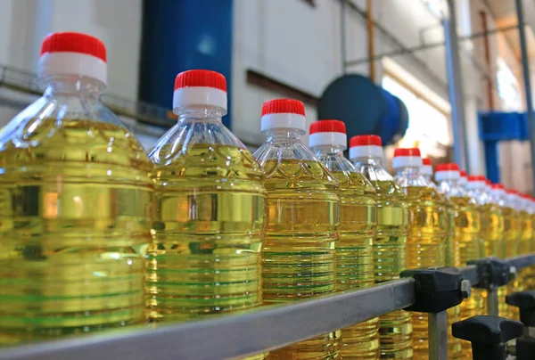 Sunflower oil in the bottle moving on production line in food processing plant