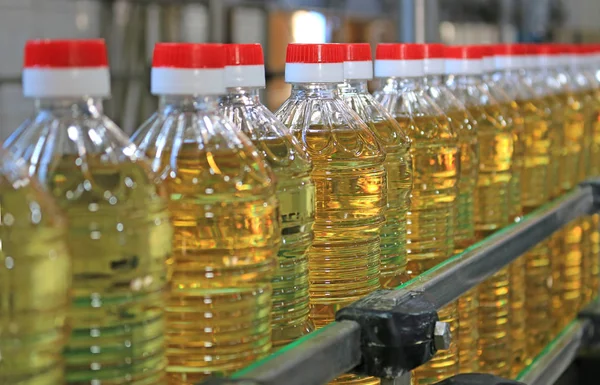 Sunflower oil in the bottle moving on production line in food processing plant