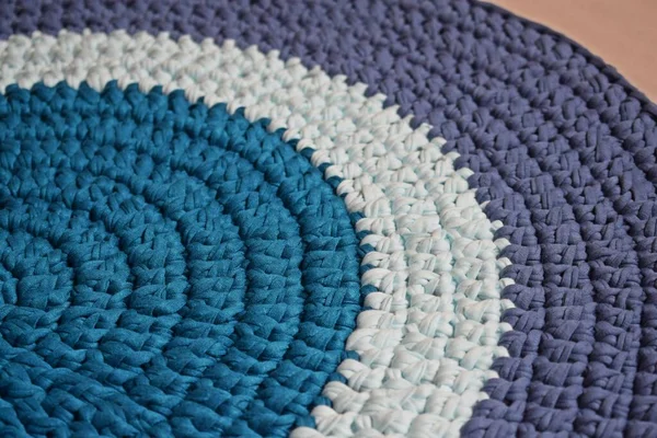 Round rug made of handmade knitted yarn.Crocheting.It will add warmth and comfort to the interior of the house.