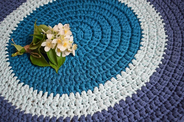 Round rug made of handmade knitted yarn.Crocheting.It will add warmth and comfort to the interior of the house.