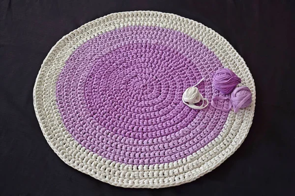 Round lilac handmade rug.Crocheting from knitted yarn.