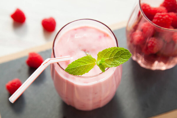 Raspberry milkshake served with mint leaf, upper viewpoint