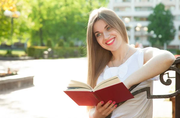 Menina Sorrindo Bonita Sentada Banco Parque Verão Com Livro Vermelho — Fotografia de Stock