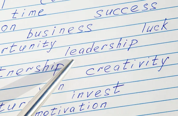 コピーブックのやる気を起こさせる言葉の中で書かれた リーダーシップ という言葉を指すペン — ストック写真