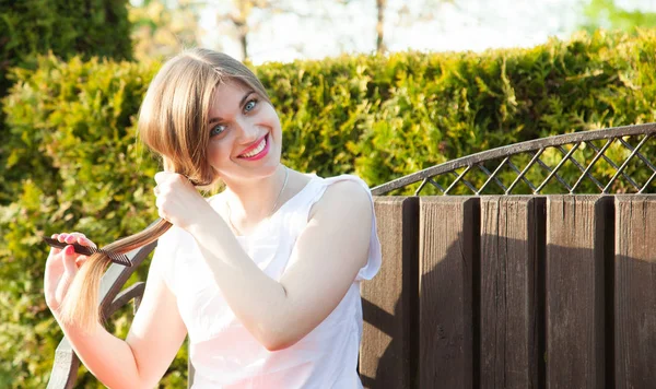 Charming Young Blonde Woman Combing Her Hair Sitting Bench Summer — Stock Photo, Image