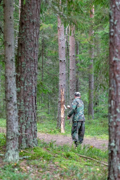 Man throwing knife in forest