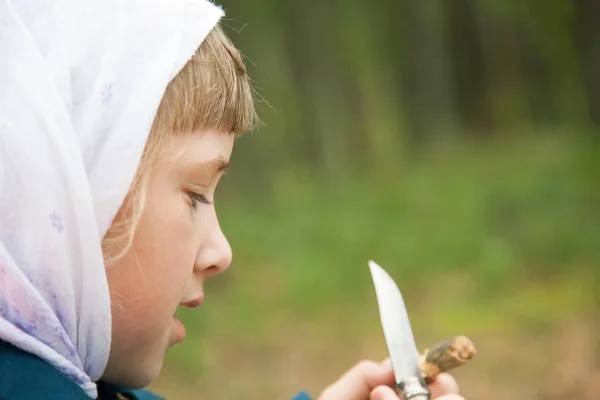 Cute Little Girl Carefully Carving Wooden Toy Outdoors — Stock Photo, Image