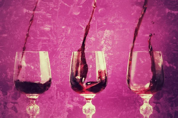 Poster in grunge style. Red wine is poured into a glass with splash.