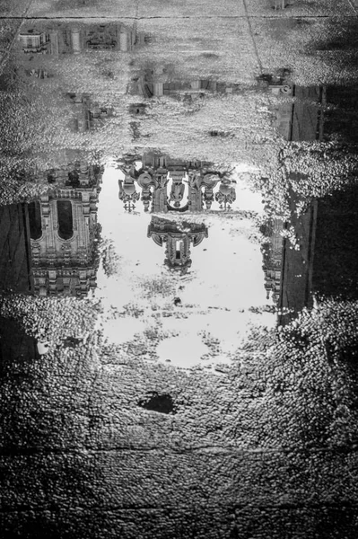 Reflection of the Cathedral of Santiago de Compostela in a rainny autumn morning. Black and white.