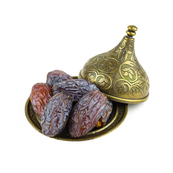 Beyaz arka planda bronz kaselerde tarihler. Türkçe Adı: HURMA.
