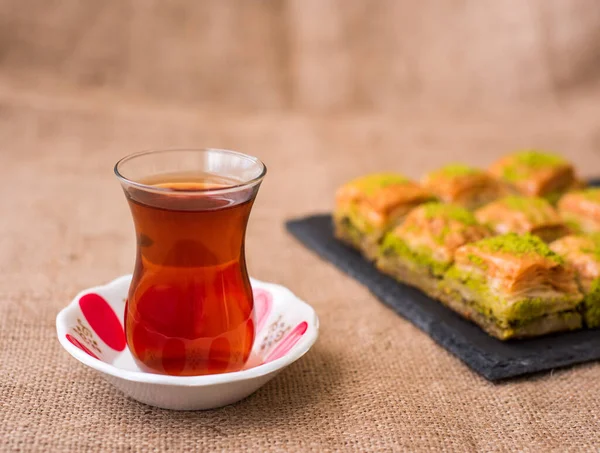 Turkish sweet baklava on plate with Turkish tea.