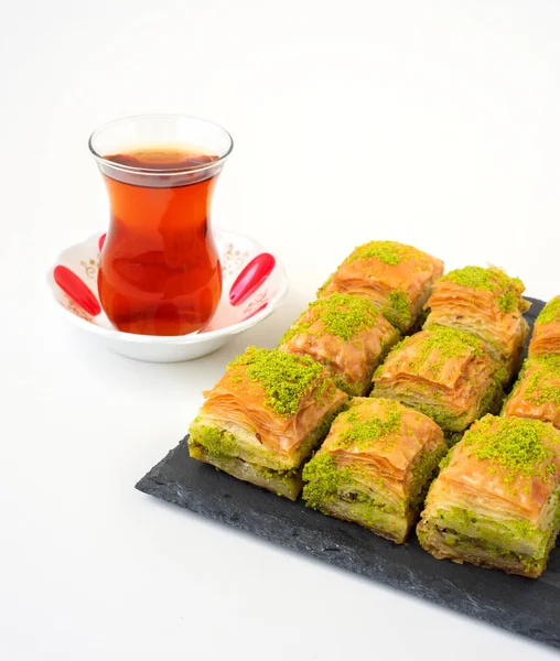 Turkish sweet baklava on plate with Turkish tea.