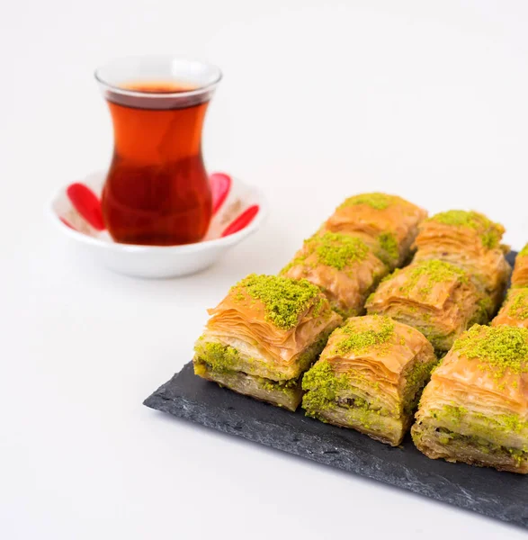 Turkish sweet baklava on plate with Turkish tea.