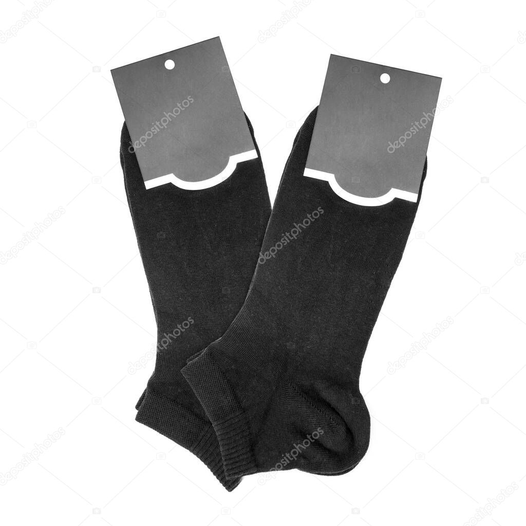 Two black socks with tags on white background