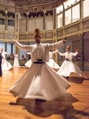 ISTANBUL, TURKEY - APRIL 17, 2016: Whirling Dervishes Ceremony. Sufi Whirling Dervishes Ceremony at Galata Mawlawi House Museum (Galata Mevlevihanesi Muzesi). Whirling Dervishes. clipart