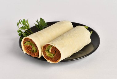 Traditional Turkish Raw Meat Wrap (Turkish Name: Cig Kofte Durum). Raw Meat in roll of bread lavash. Turkish food. Isolated on white background clipart