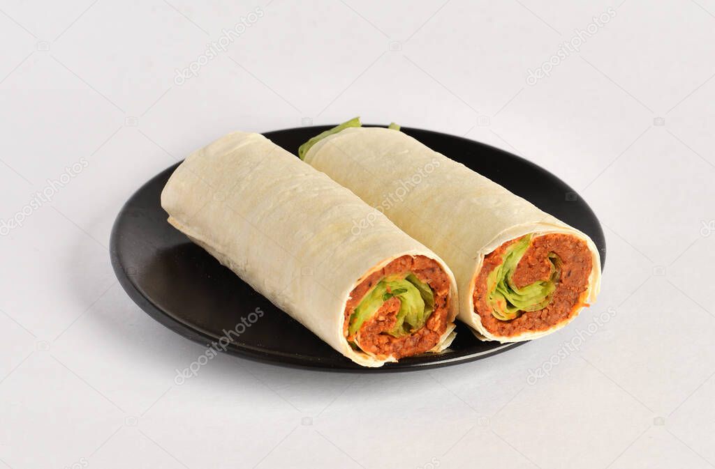 Traditional Turkish Raw Meat Wrap (Turkish Name: Cig Kofte Durum). Raw Meat in roll of bread lavash. Turkish food. Isolated on white background