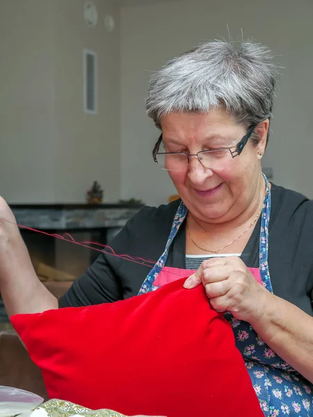 Older Woman Braiding Red Pillow Case — Stock Photo, Image